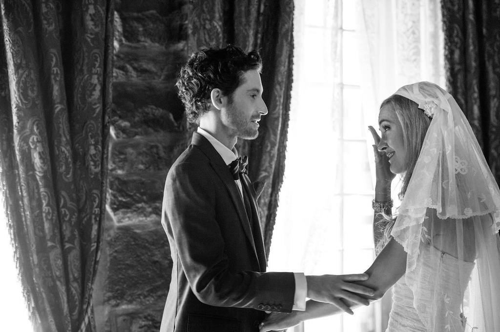 Bride wiping her tears after seeing the groom for the first time on wedding day