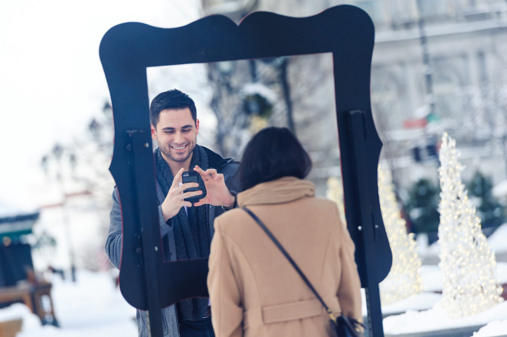 Man snapping a photo of his girlfriend in Old Montreal