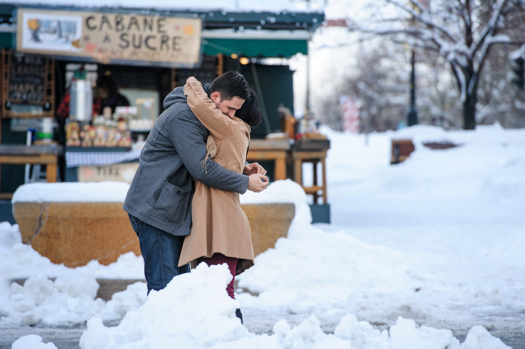Couple hugging after the surprise proposal