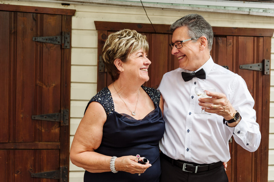 Bride's parents smiling at each other in back yard
