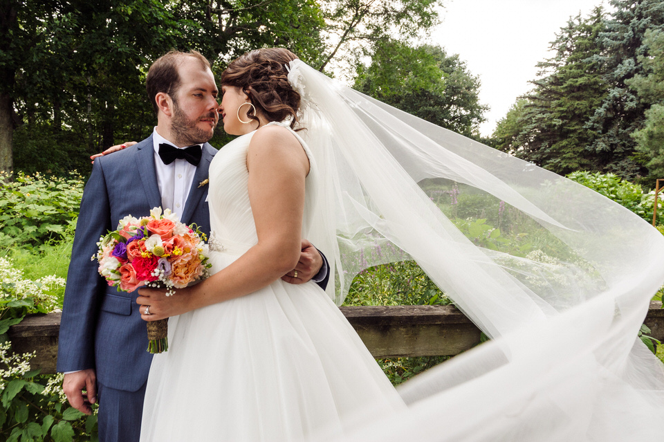 Wedding portrait of bride and groom with long veil at Parc Jean-Drapeau