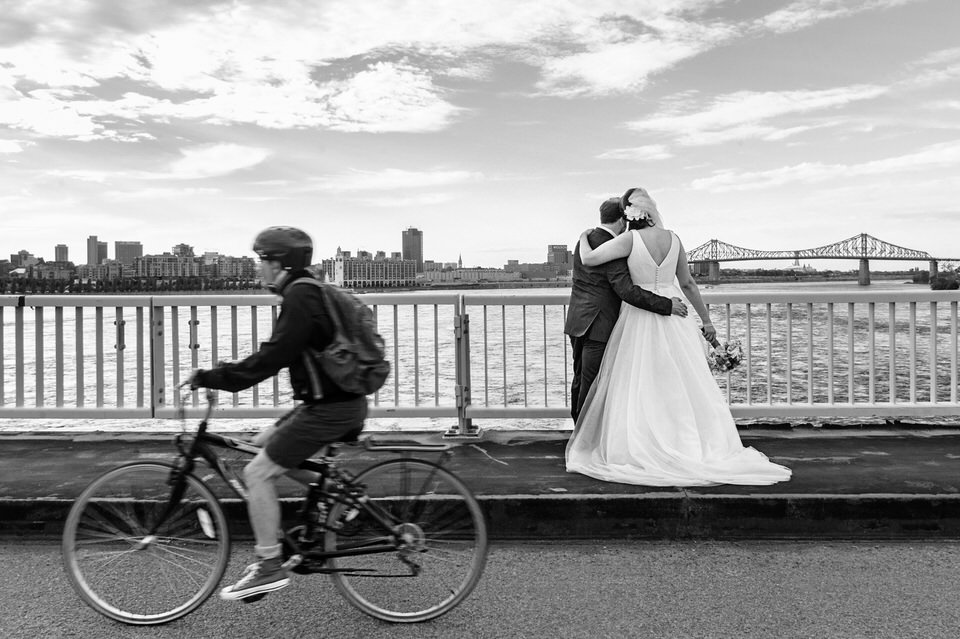  bike goes by as wedding couple enjoys the view of Montreal from the bridge