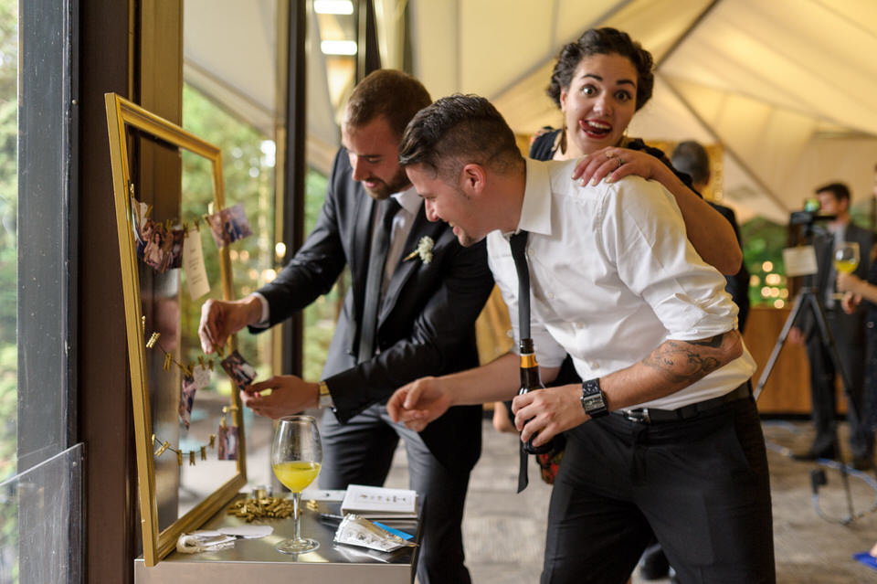 Wedding guests pinning up polaroids at La Toundra wedding venue