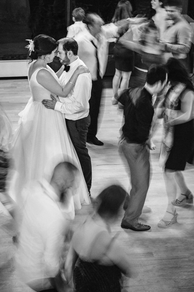 Blurry long exposure of bride and groom still on the dance floors as others move around them