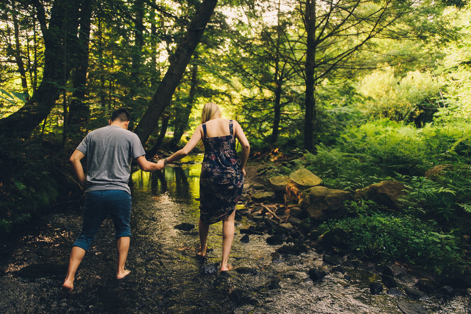 Couple hand in hand walking in creek