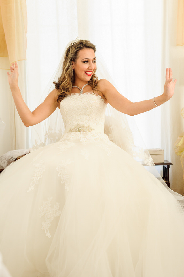 Bride dancing in her room in wedding dress