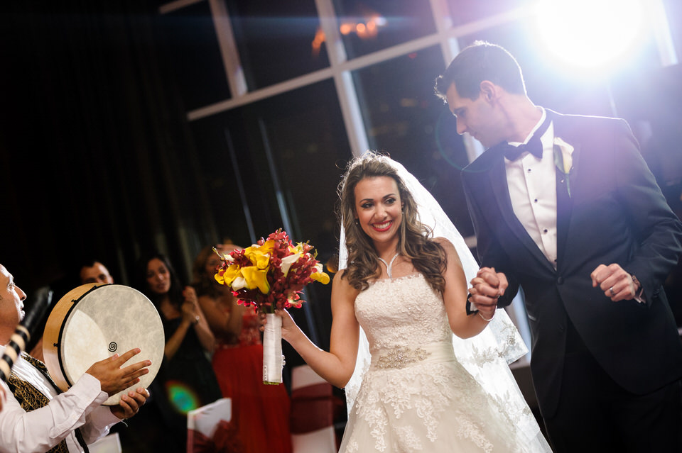 Bride and groom enter accompanied by zaffe group