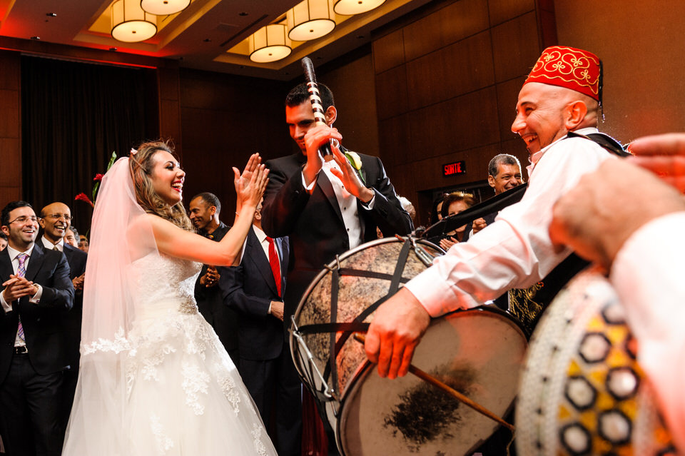 Bride and groom drumming on big drum