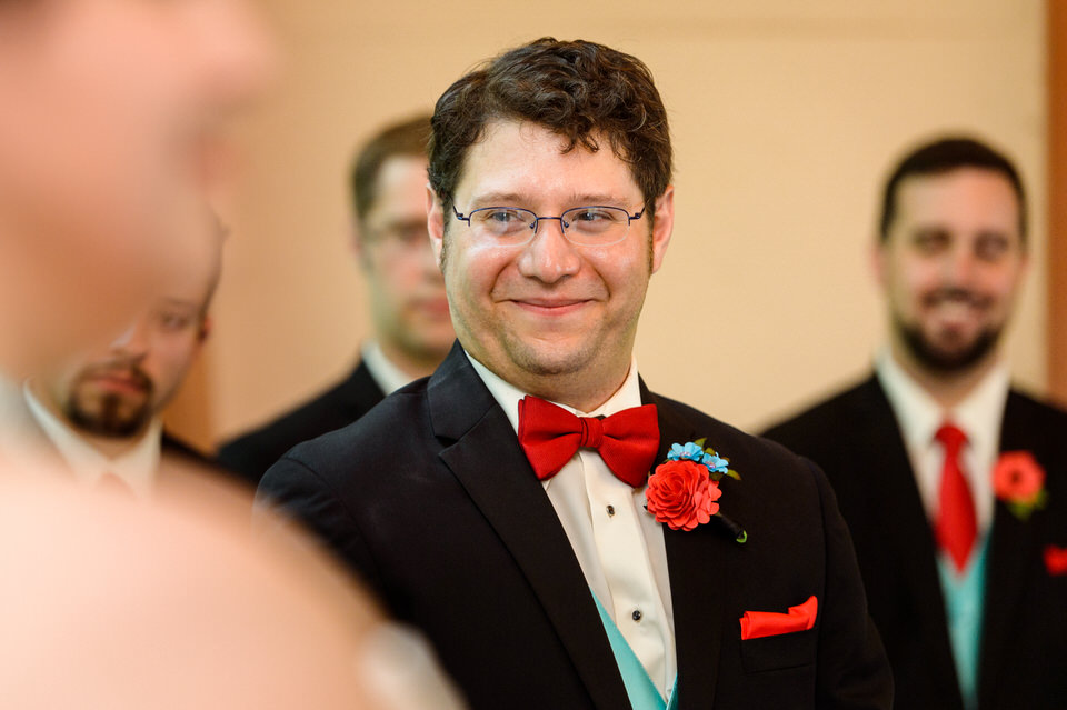 Groom smiling at bride during wedding ceremony