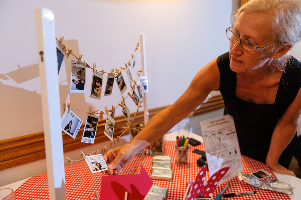 Instant photos of guests pinned to a mini clothesline