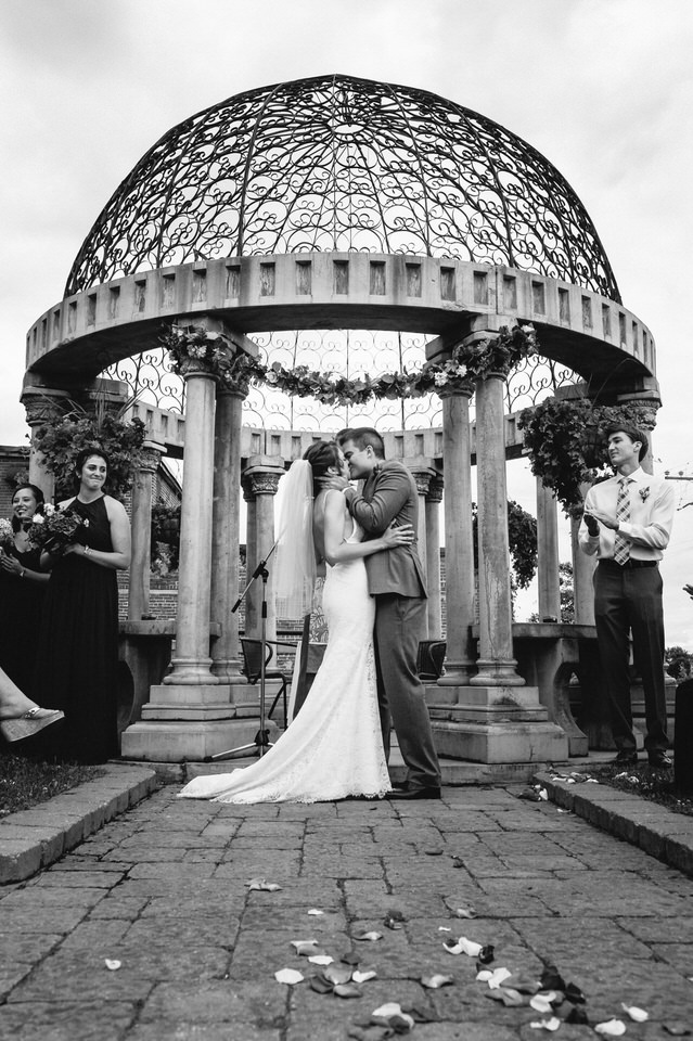 First kiss as married couple in front of gazebo