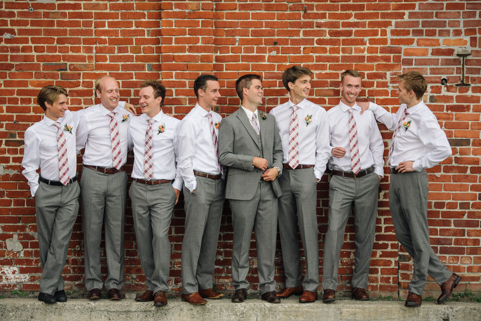 Groomsmen portrait in front of brick wall