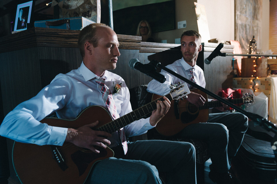 Groomsmen playing a song at the wedding reception