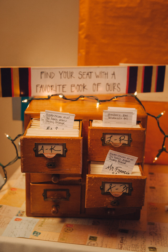 Library-theme wedding place cards so guests can find their seat with a book