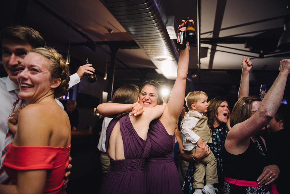 Bridesmaid raising her beer bottle