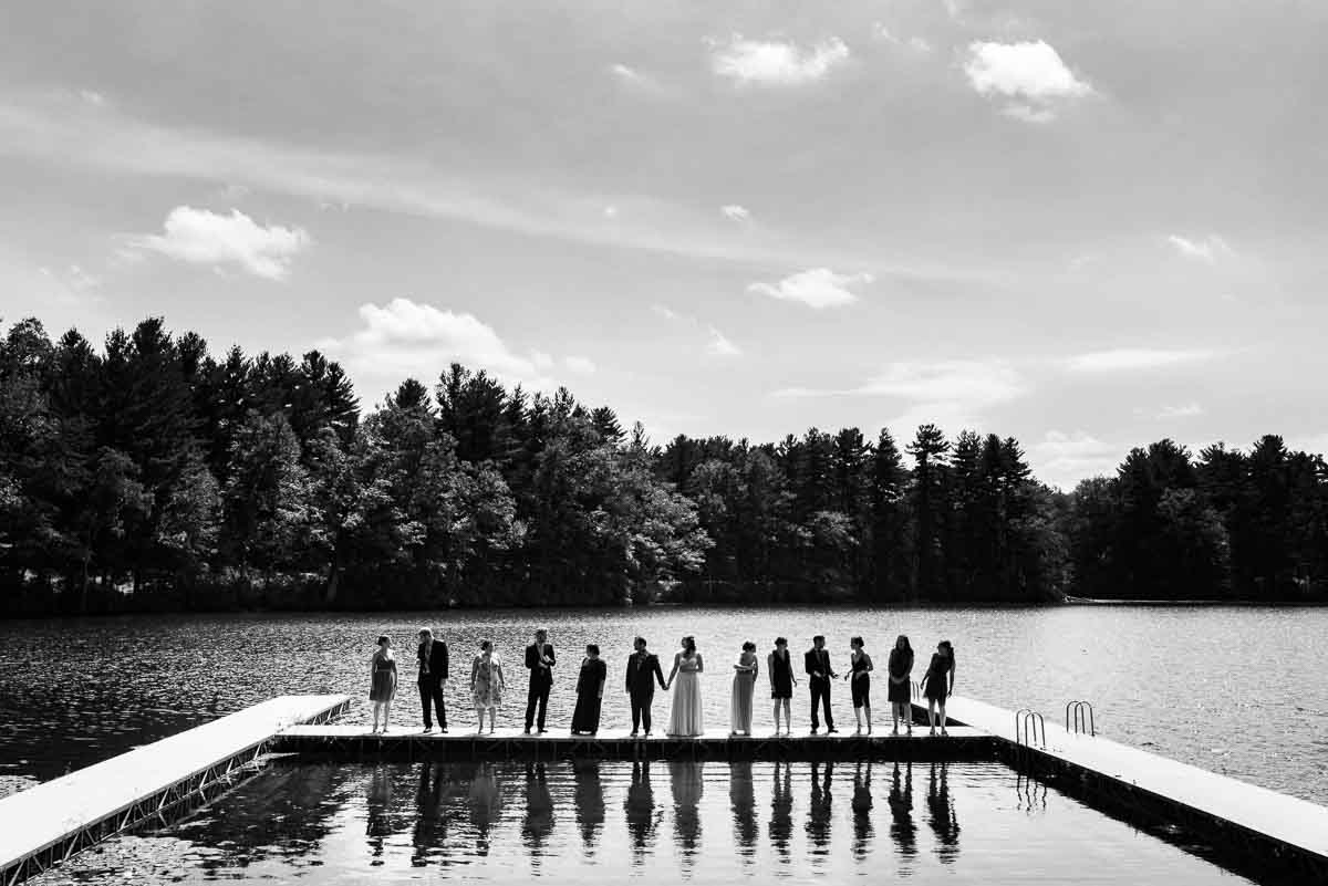 Wedding party portrait on a dock at a lake
