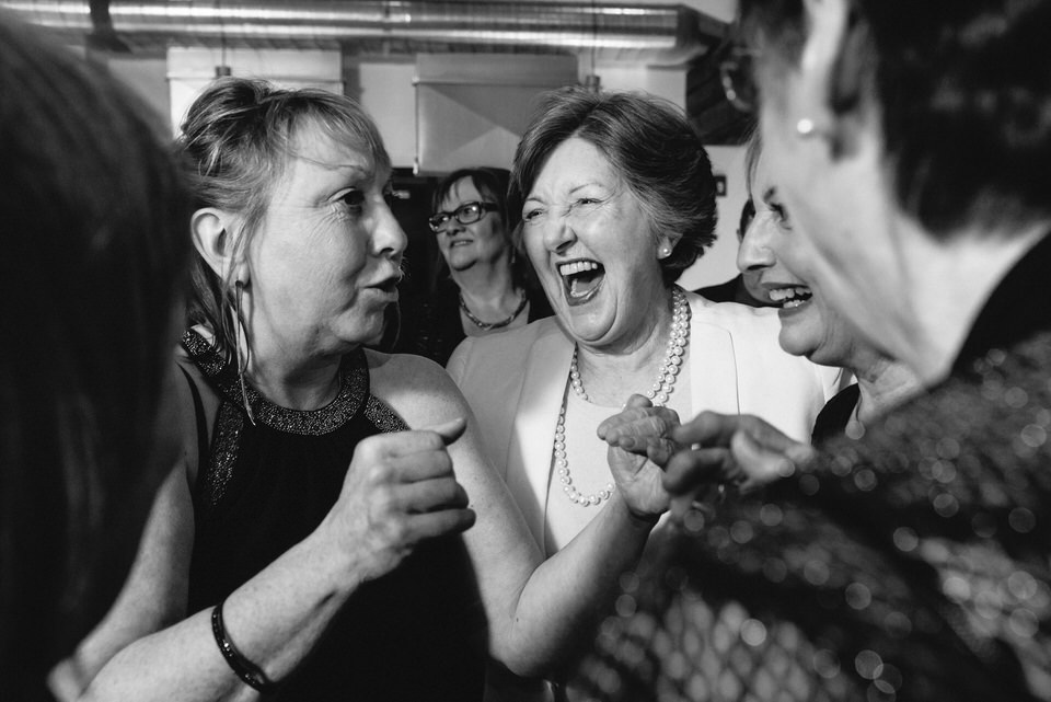 Guests laughing together at wedding reception