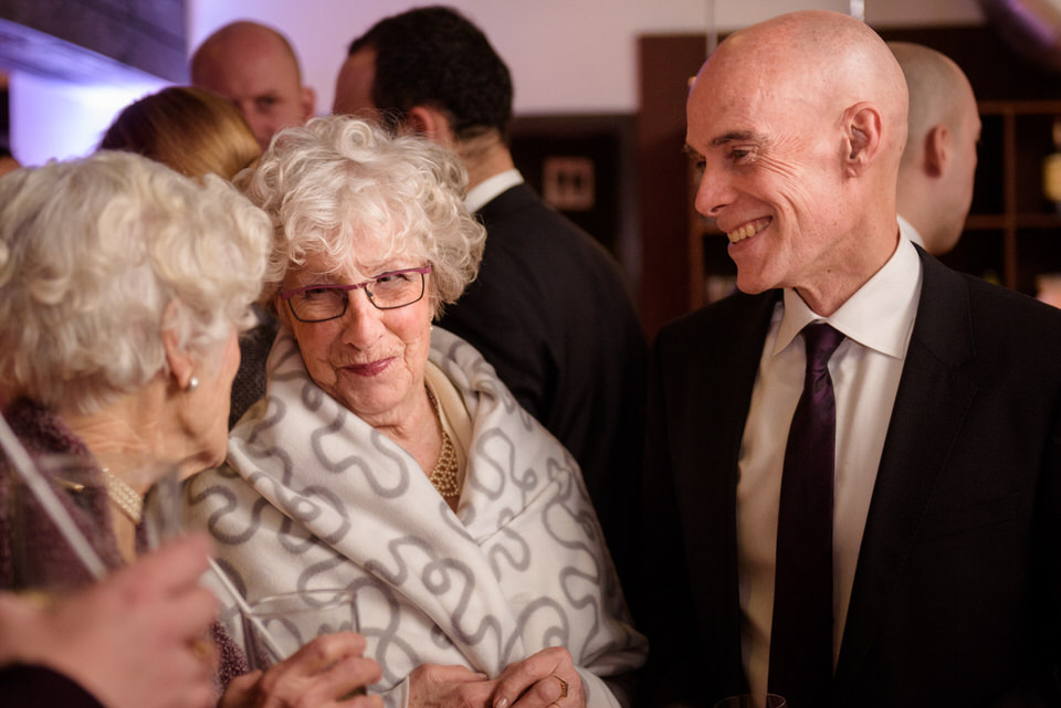 Wedding guests chatting together in winter wedding reception