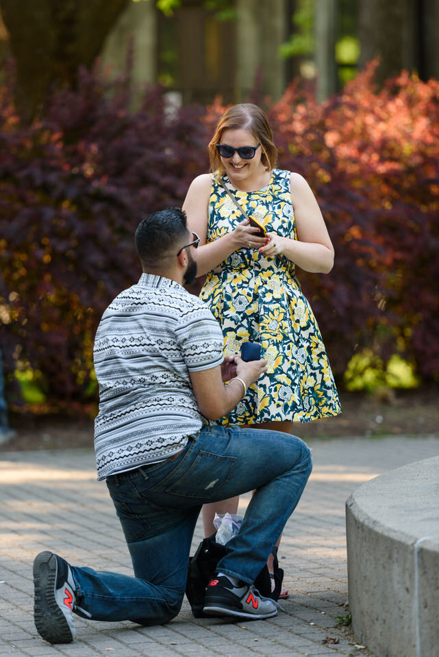 Man kneels down for surprise proposal to girlfriend