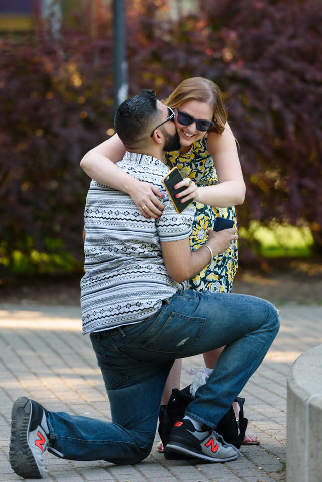 Woman hugs man after surprise proposal