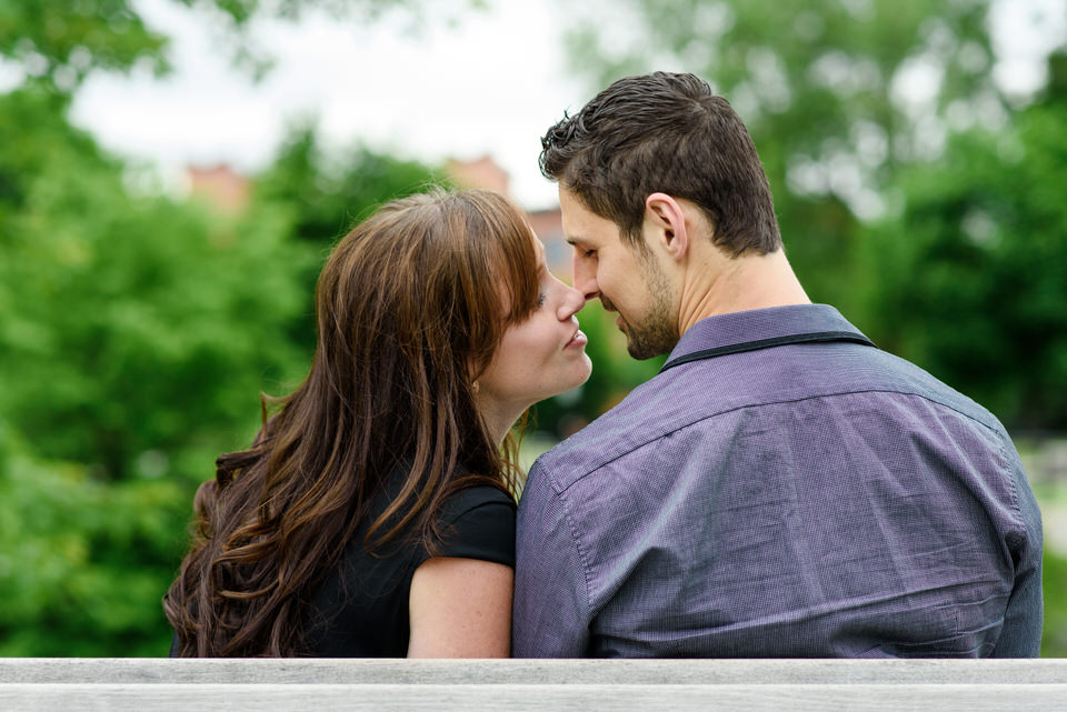 Couple sitting on a bench kissing