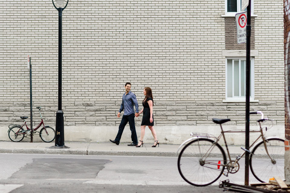Couple walking along street past bicycles in Little Burgundy