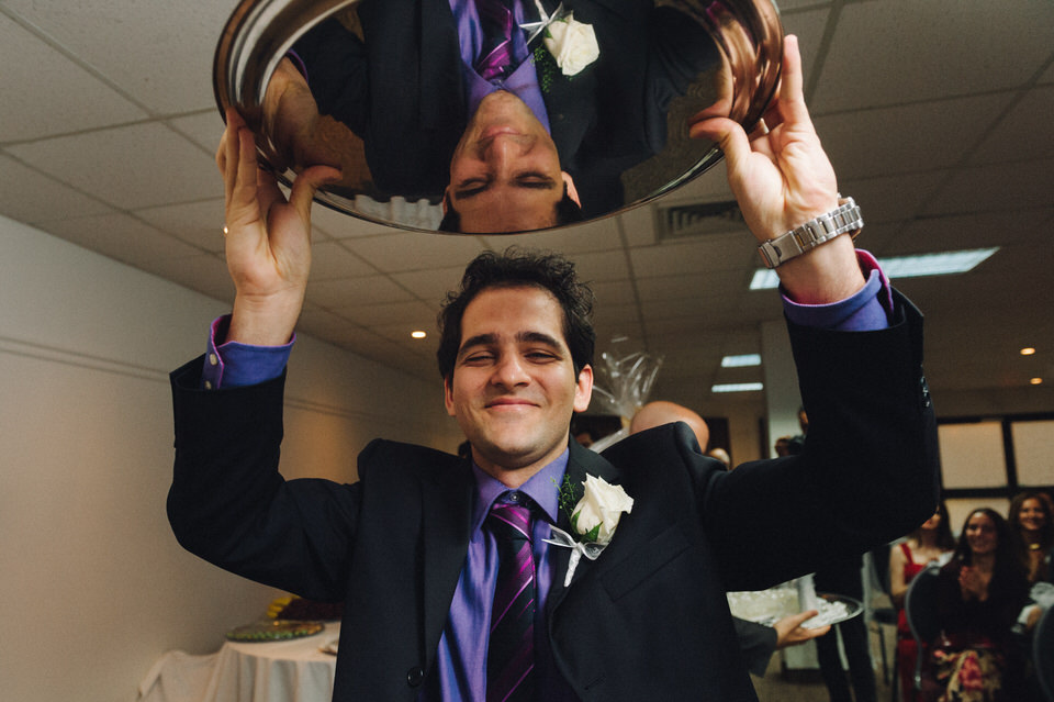 Groomsman carrying tray during Persian wedding in Quebec