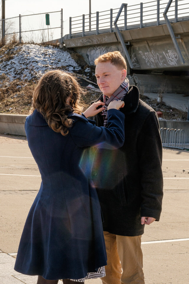 Engaged couple with coats in chilly engagement photo