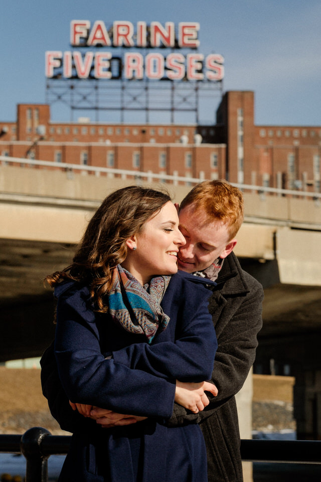 Wedding couple hugging with Farine Five Roses sound behind them