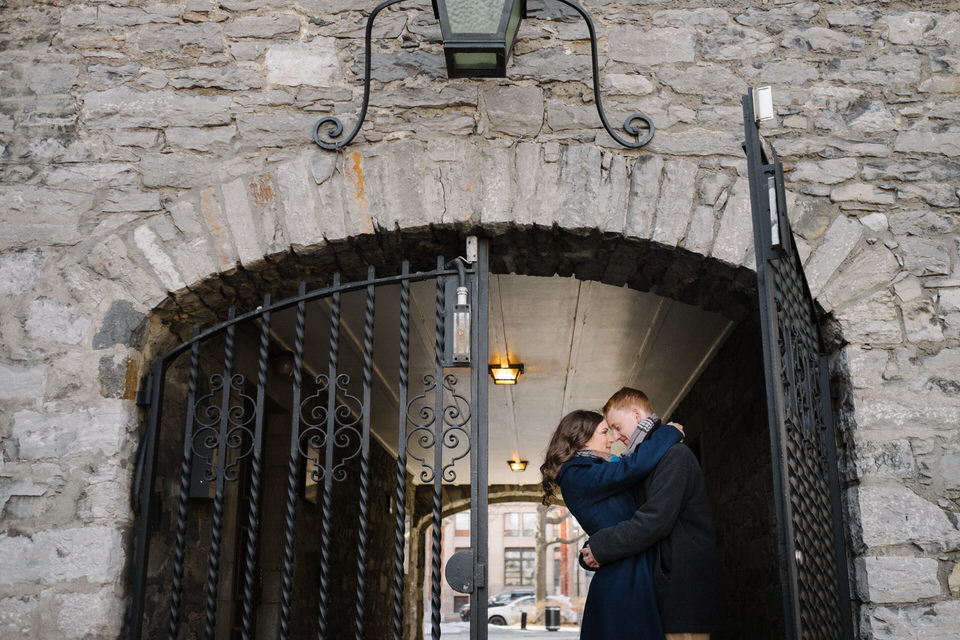 Engaged couple kissing in gateway