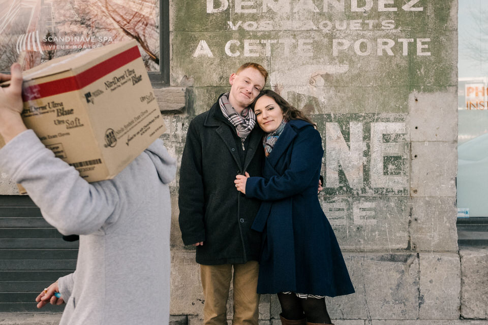 Engagement photo with man walking by