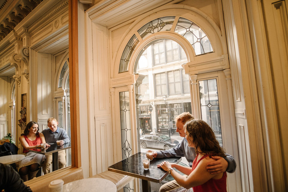 Engagement photo of couple enjoying coffee in Old Montreal