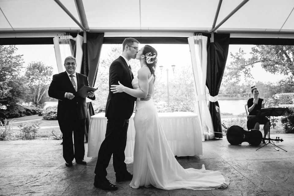 First kiss at wedding under tent