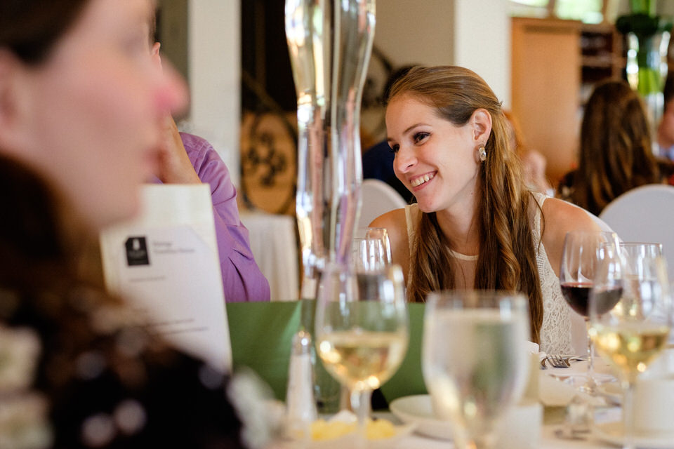 Wedding guest smiling at dinner
