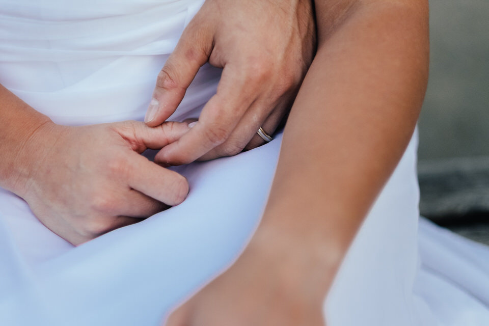 Close up of wedding couple holding hands