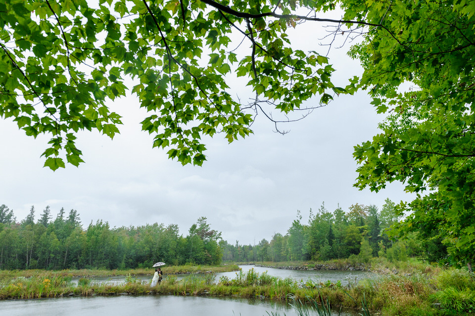 Couple walking along the lake in the rain