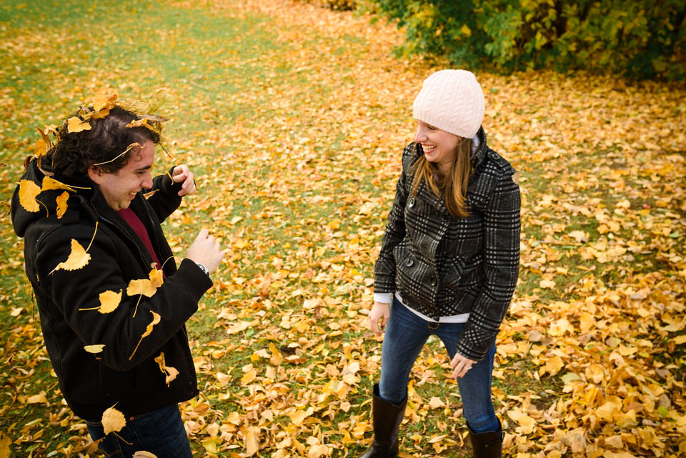 couple has fun with autumnal leaves