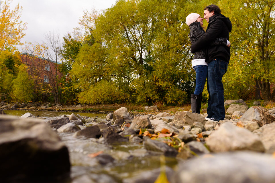 Artistic shoot of couple holding each other near river