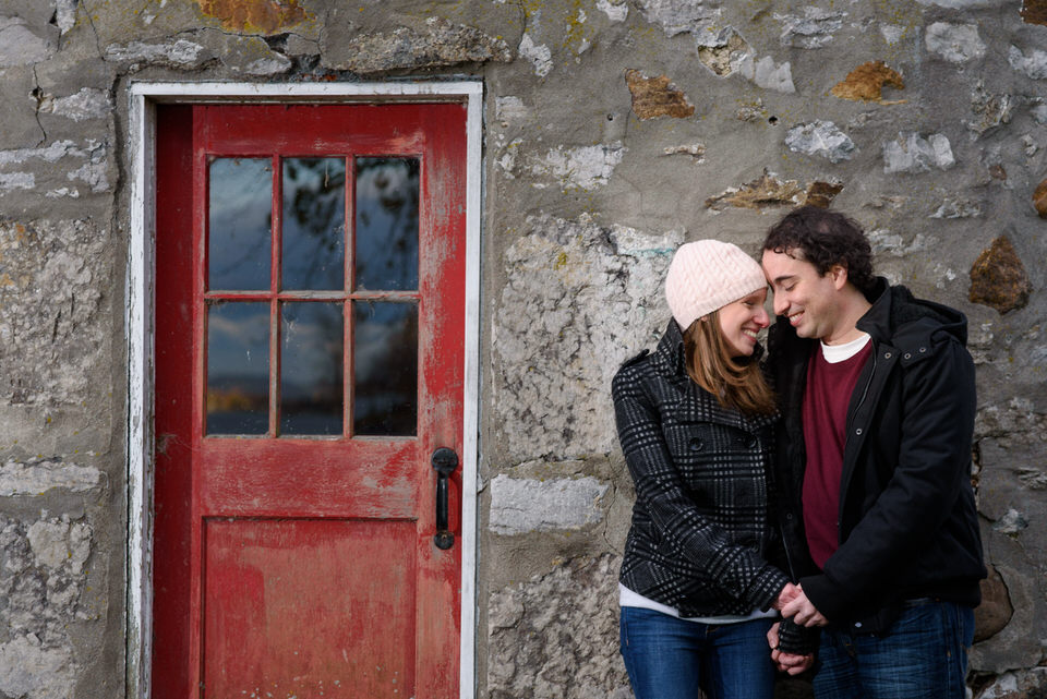 Couple holding hand in front of red door