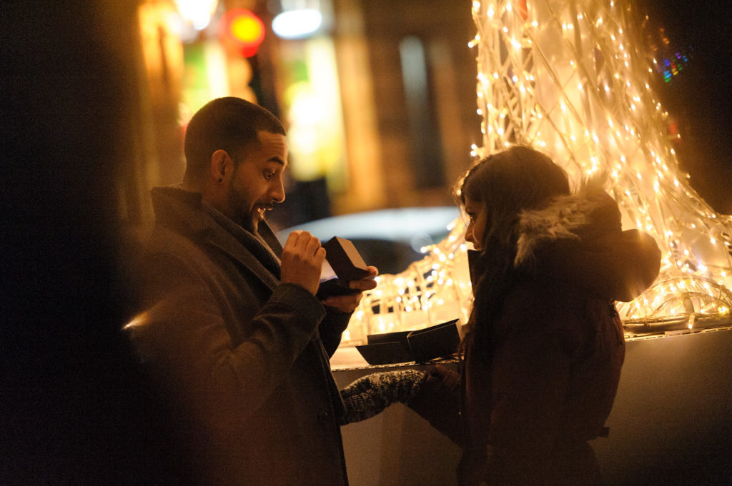 Man peeking into surprise proposal ring box