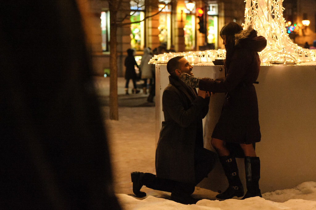 Man kneeling down to proposal to his girlfriend