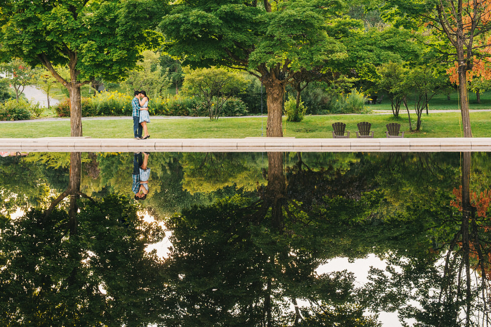 Engagement photos with reflecting pond at Park Jean-Drapeau