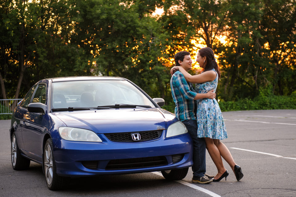 Engaged couple at sunset in parking lot of Jean-Drapeau Park