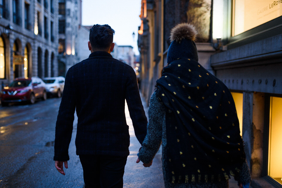 Couple walking holding hands in Old Montreal