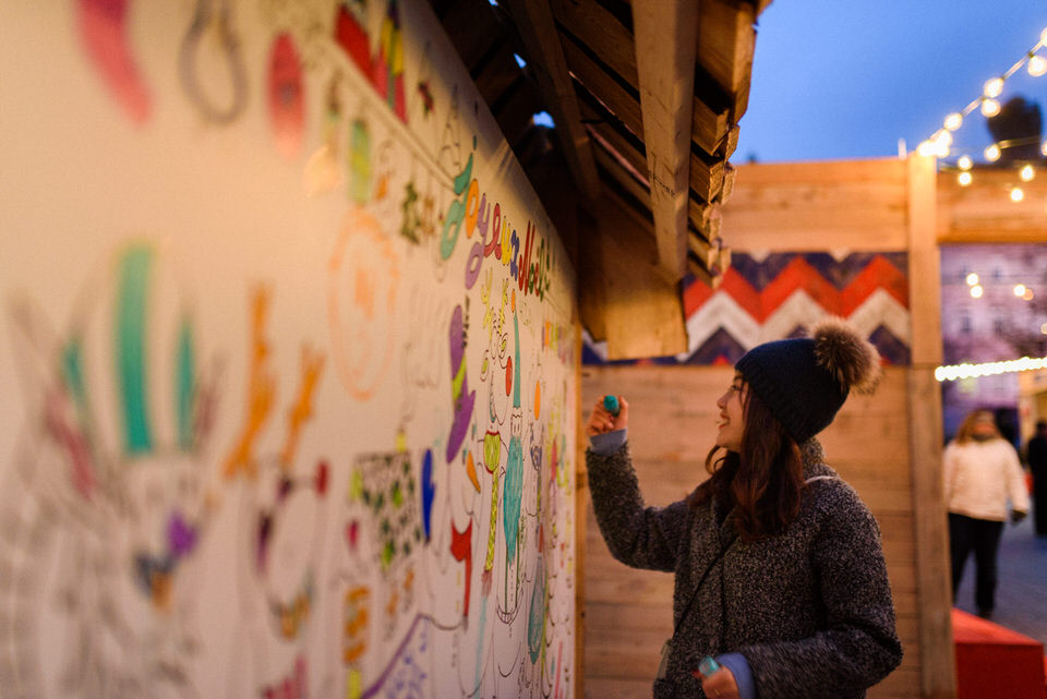 Couple leaving a message on a community drawing board