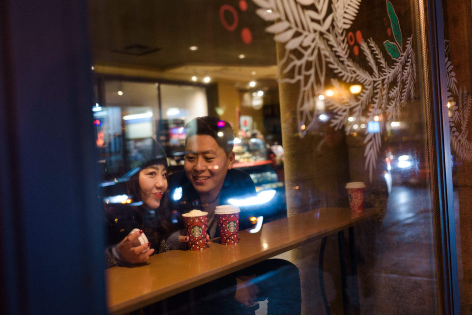 Couple warming up with coffee after photoshoot