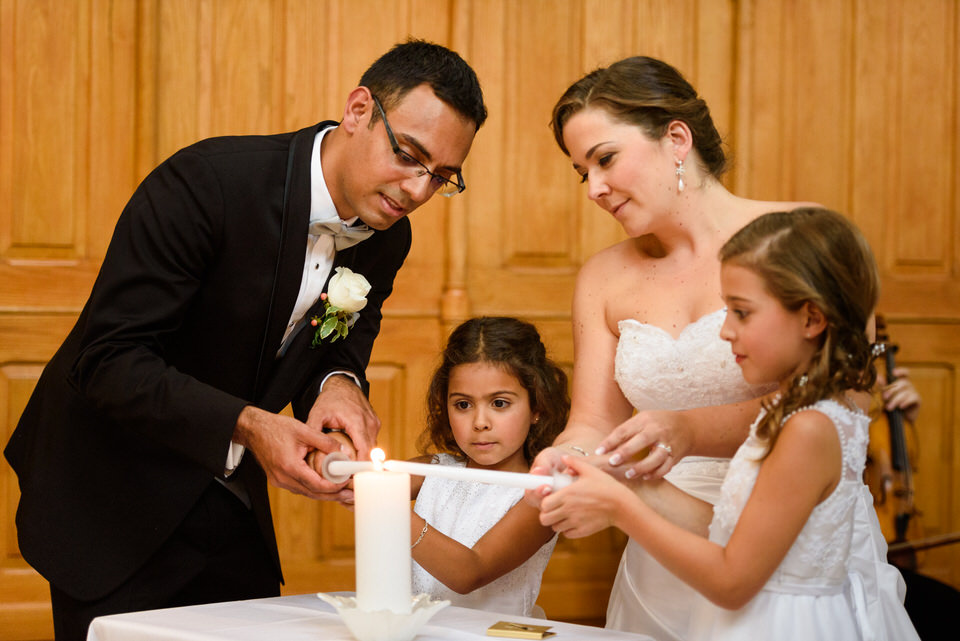 Family lighting candles at wedding