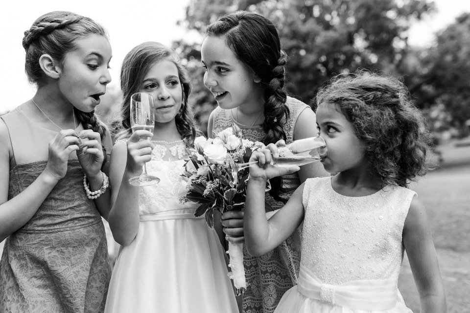 Black and white candid photo of children at Abbaye Oka wedding