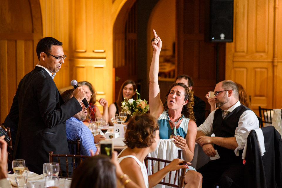 Groom singing karaoke and wedding guest singing along