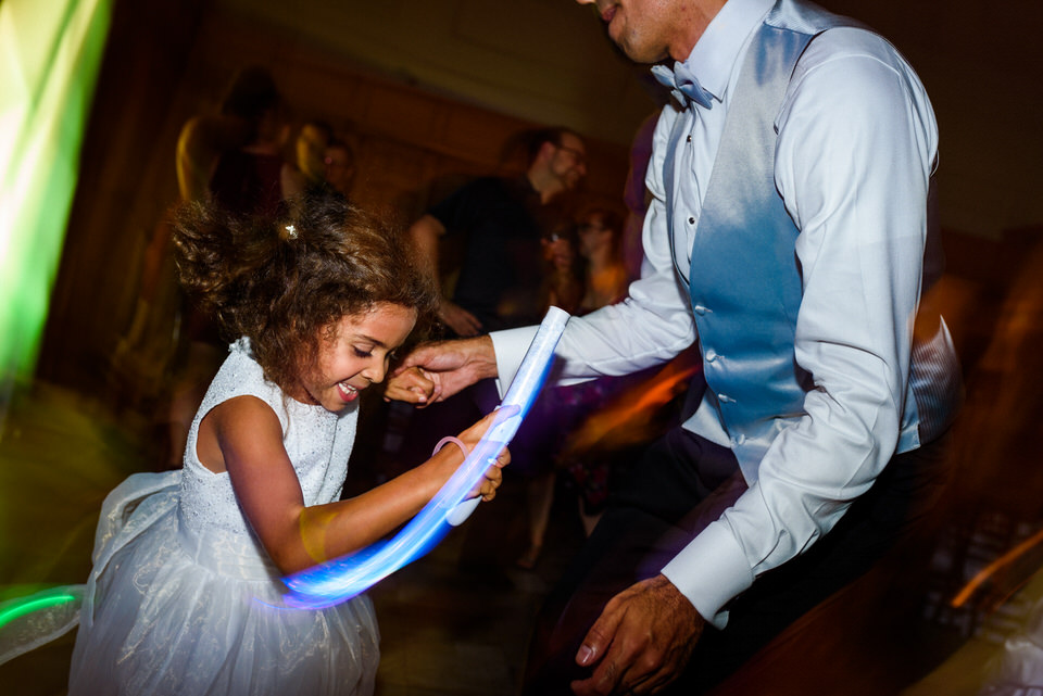 Flower girl dancing with her dad